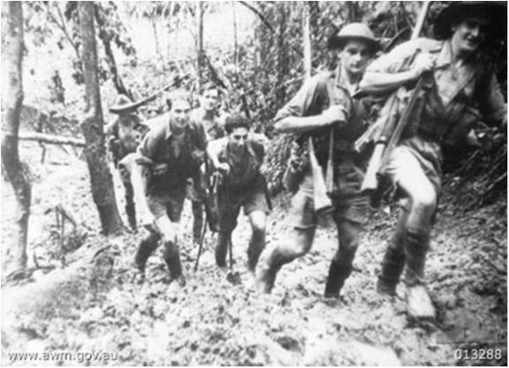 D COMPANY, 39TH BATTALION, RETURNING TO THEIR BASE CAMP AFTER A BATTLE AT ISURAVA. RIGHT TO LEFT: WARRANT OFFICER 2 R. MARSH, PRIVATES G. PALMER, J. MANOL, J. TONKINS, A. FORRESTER AND GALLIPOLI VETERAN STAFF SERGEANT J. LONG.